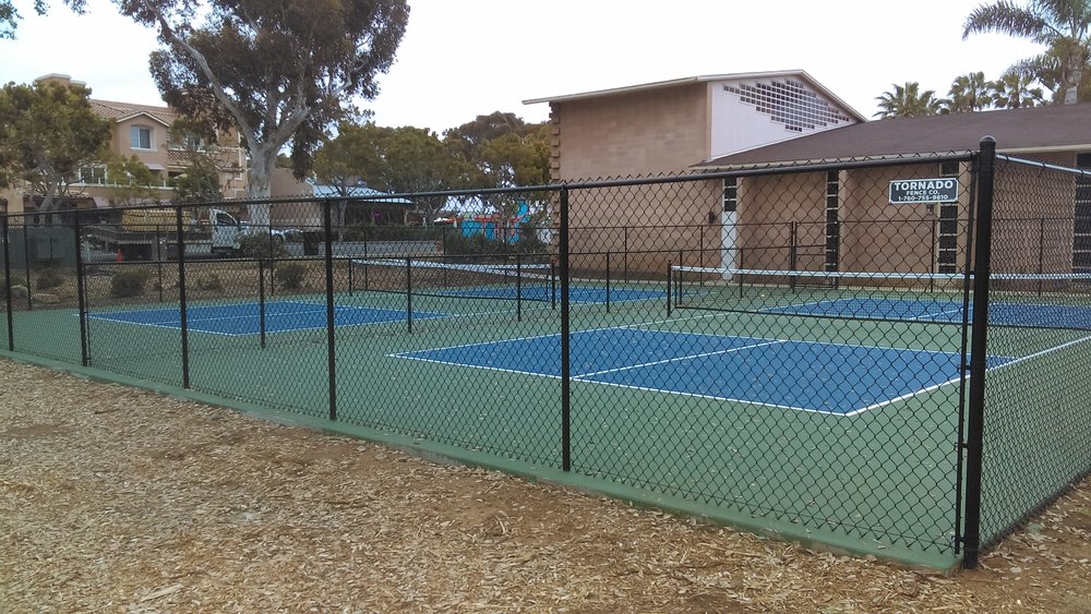 Black vinyl coated chain link fence installed by Tornado Fence
