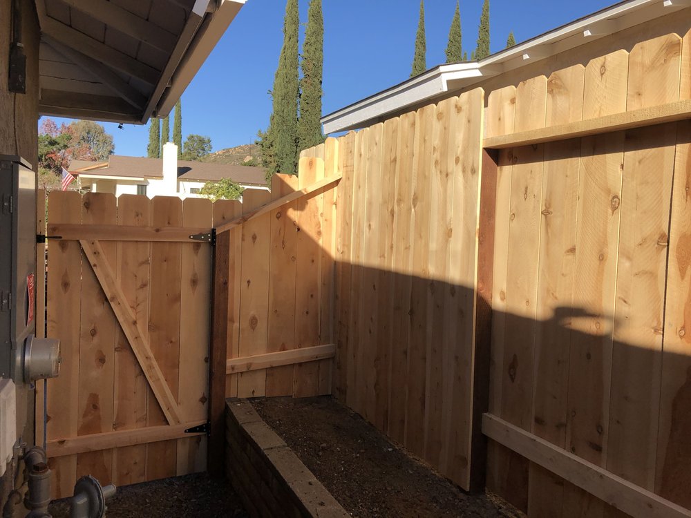 Fence stepping down a grade with a gate