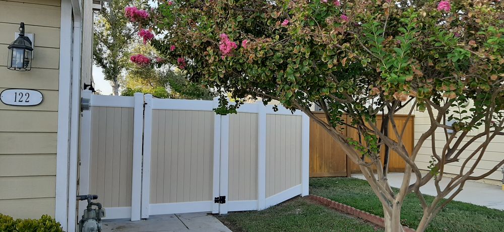 White vinyl double gate set into a privacy fence