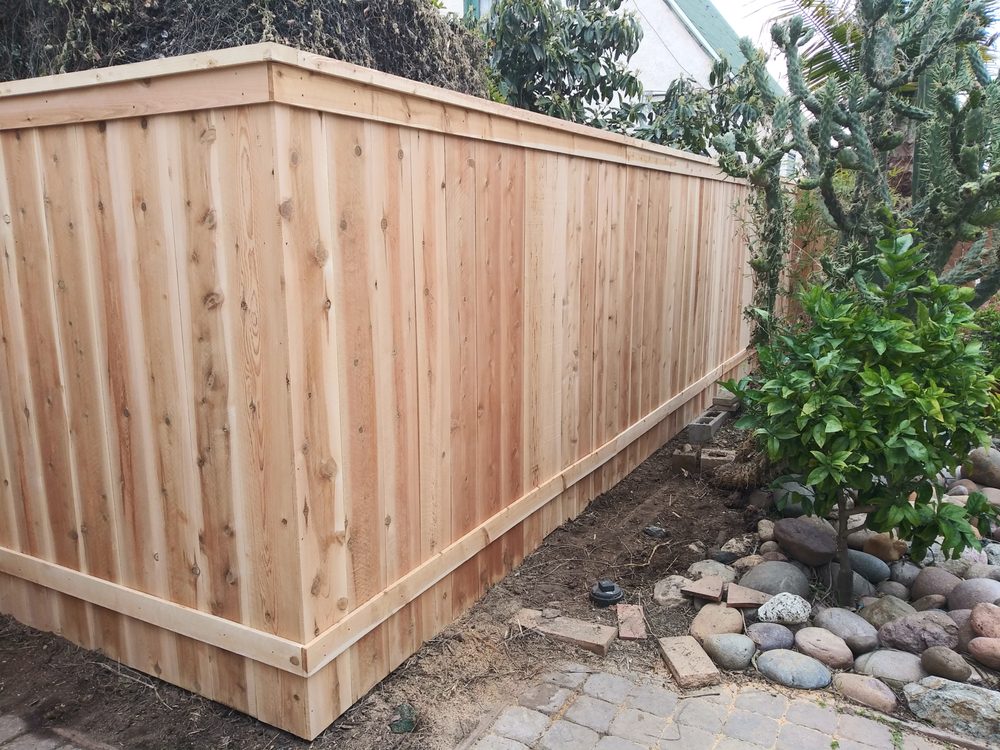 Picture frame wood fence with metal posts