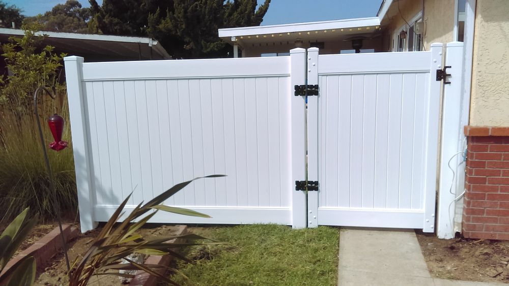 White vinyl privacy fence along a yard